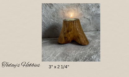 Wooden handmade candle holder for home decor shaped like a tree stump with a lit tealight candle